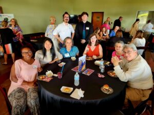 Group of people sitting at a table at a chamber mixer