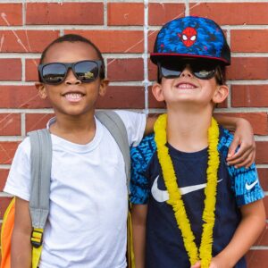 Two little boys against a brick wall