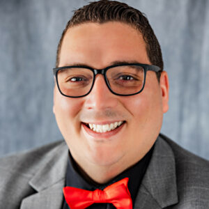 Headshot of a man in a suit and red bowtie