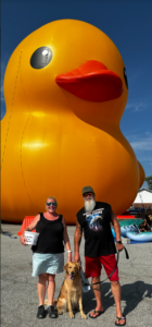 People standing in front of a big duck