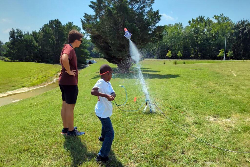 students launching model rockets