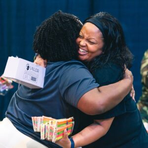 two women hugging each other