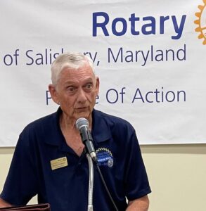 Older man speaking into a microphone at Salisbury Rotary