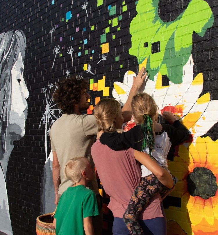 family looking at a mural