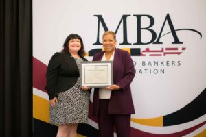 MBA Graduates holding an award