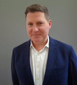 Headshot of a man in a suit