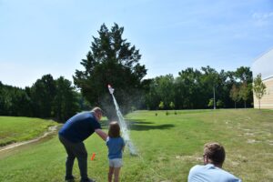 students launching model rockets