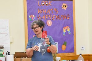 teacher holding up a model rocket