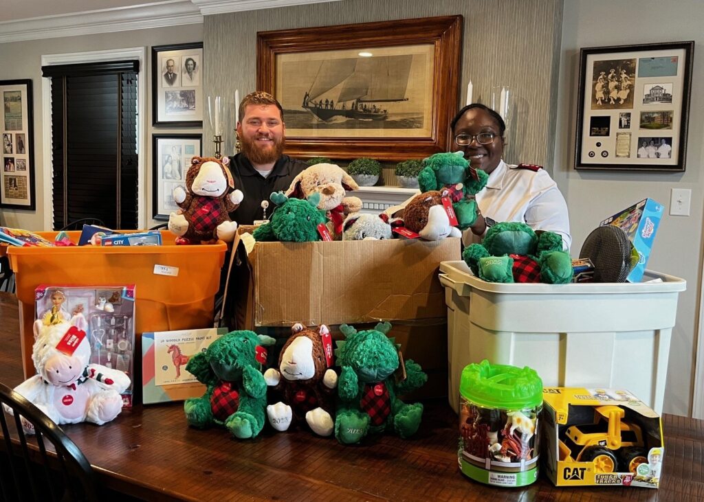 two men standing by a table full of toys 