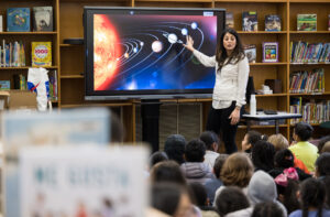 teacher lecturing students about space