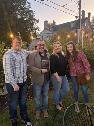 four people holding award