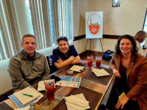 Group of people sitting around a table having lunch