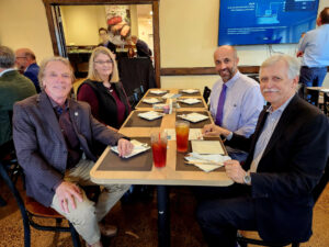 Group of people sitting around a table having lunch