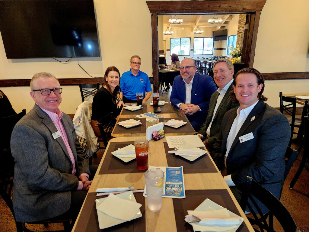 Group of people sitting around a table having lunch