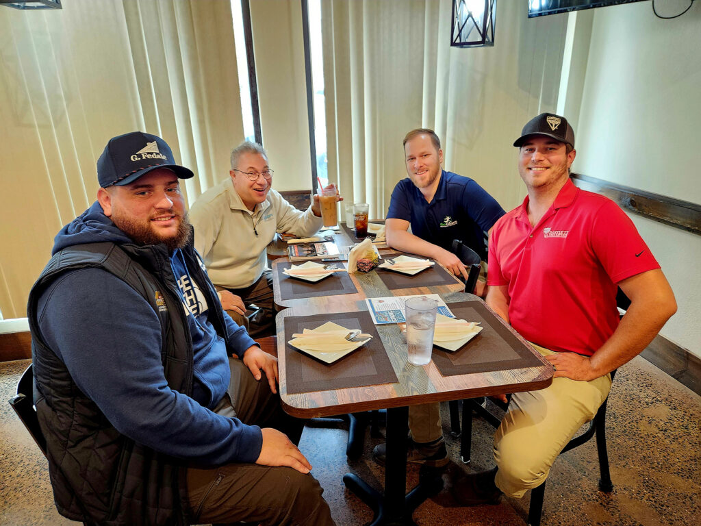 Group of people sitting around a table having lunch