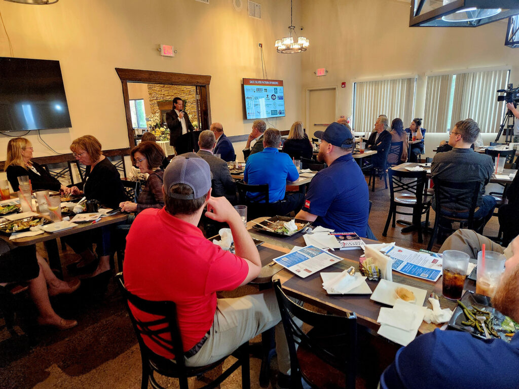 Group of people at a luncheon listening to the guest speaker