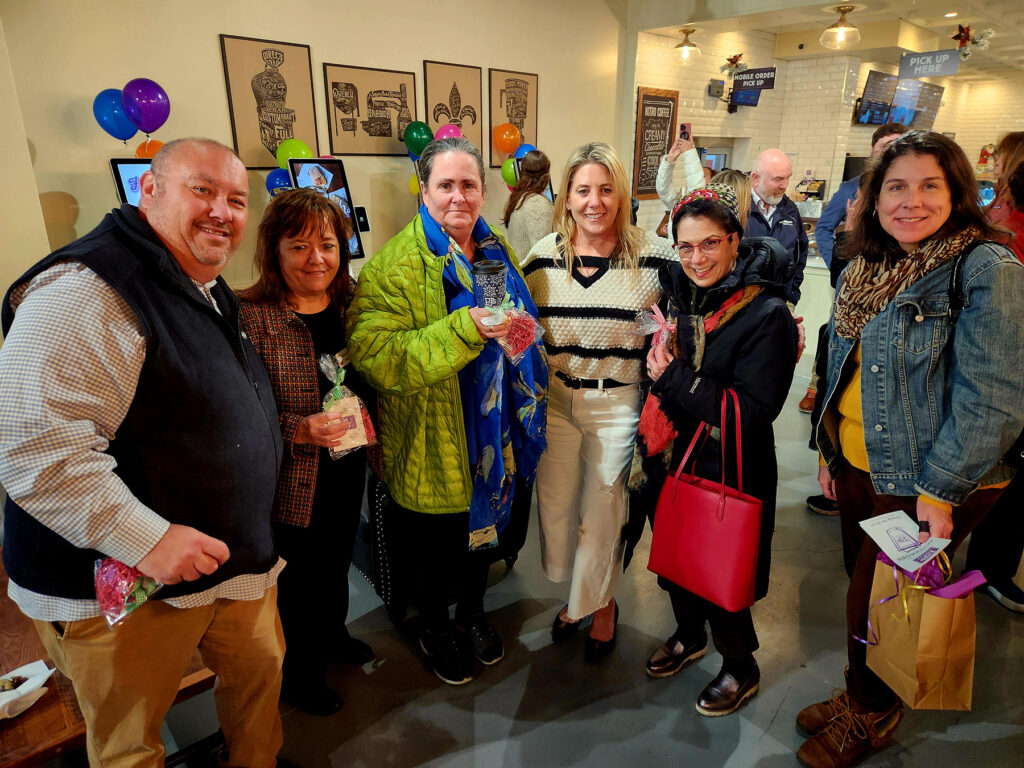 Group of ribbon cutting attendees inside PJs Coffee