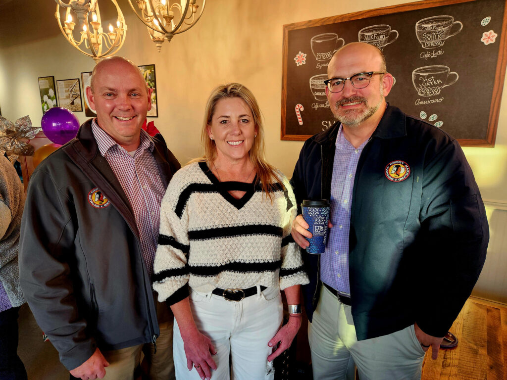 Group of ribbon cutting attendees inside PJs Coffee