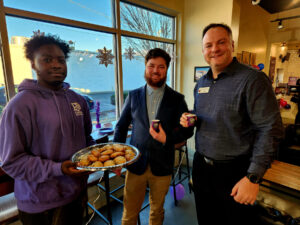 Group of ribbon cutting attendees inside PJs Coffee