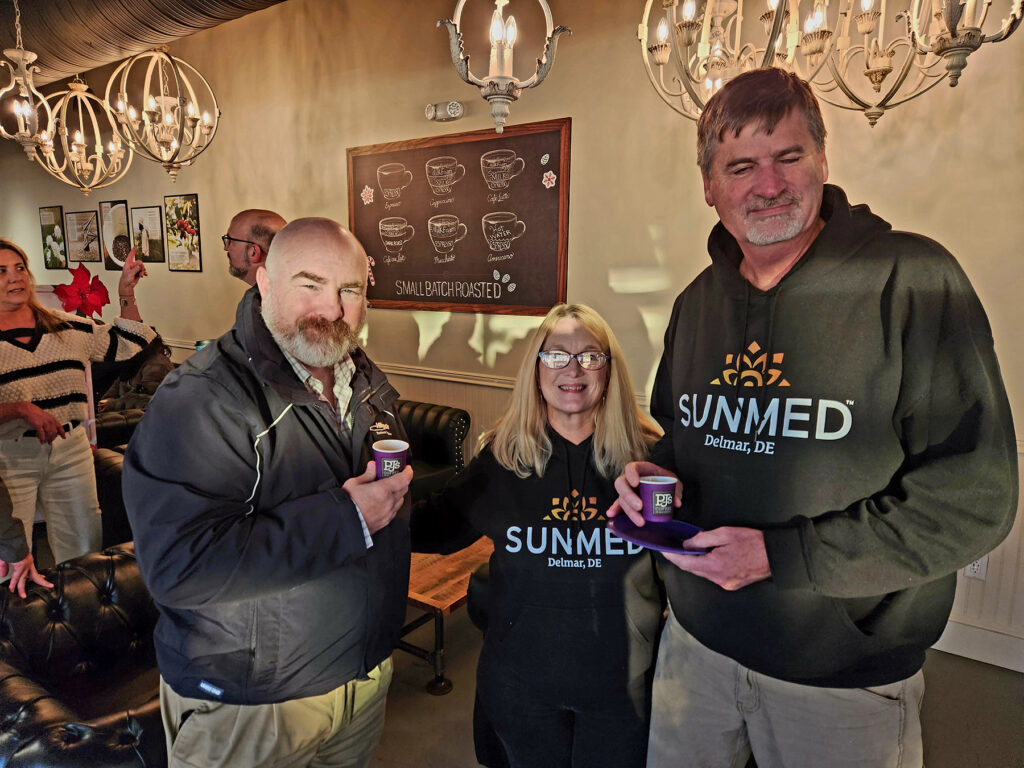 Group of ribbon cutting attendees inside PJs Coffee