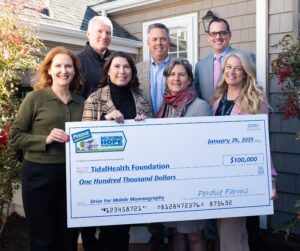 People holding a big check