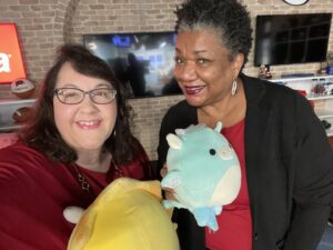 Two ladies holding stuffed animals