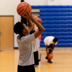 boy shooting a basketball