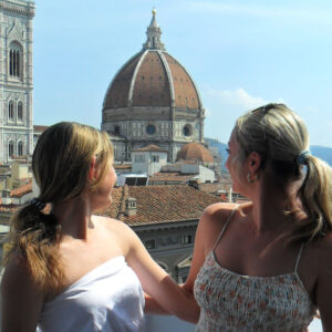 Two girls looking over their shoulder in Italy