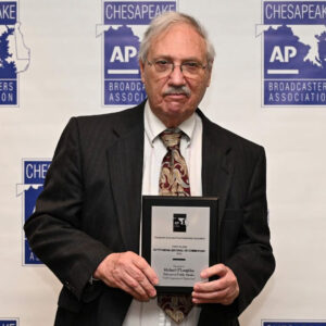 don rush man holding an award