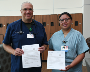 tidalhealth guardian angel two people holding papers