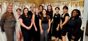 Downtown Bridal's team, including owner Maria Demetriou (center, back)