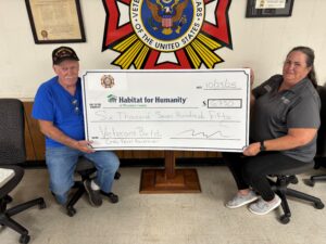 A man and a woman holding a big check.