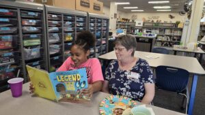 A woman and a child reading a book