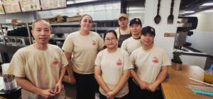 Cindy and Winnie (far right) with the rest of their staff at Wok N Bowl