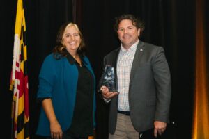 Heather Wilson, GiveSendGo presented the the Medium Business of the Year Award to Chris Eccleston, Delmarva Veteran Builders.