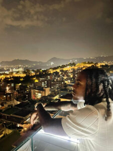 A boy overlooking a city a night