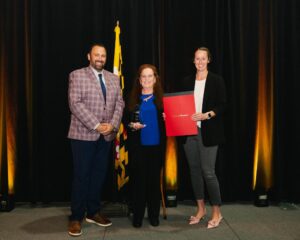 Justin Polizzi and Laura Soper present the Tourism Hospitality Award to Patty Shea, Marriott Hotels