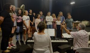 Annie Play Children singing practicing for a musical.