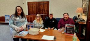 Table of guests smiling for a photo
