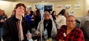 Three guests smiling for a photo