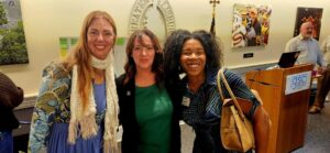 Three guests smiling for a photo