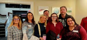 Seven guests smiling for a photo