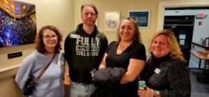 Four guests smiling for a photo