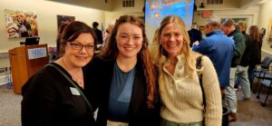 Three guests smiling for a photo