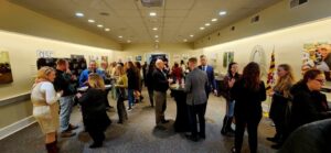Event space filled with guests discussing amongst each other