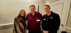 Three guests smiling for a photo