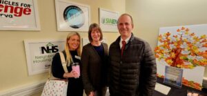 Three guests smiling for a photo