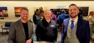 Three guests smiling for a photo