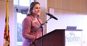 Jessica Clark speaking at podium.