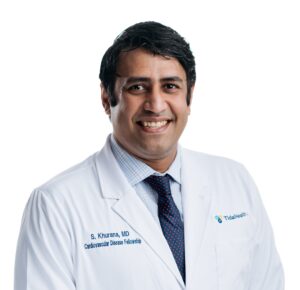 A doctor smiling for his portrait